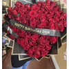 Large bouquet of red roses with a birthday ribbon