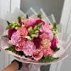 Pink rose and carnation bouquet wrapped in pale pink paper