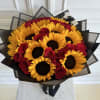 Bouquet of yellow sunflowers and red roses wrapped in layered black paper