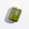 Green soy candle in a glass jar with a metal lid
