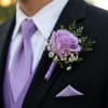 A single lavender rose boutonniere that reads as quietly romantic-perfect for a