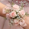 Pale pink spray roses clustered with delicate white filler and airy green