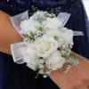Clustered white spray roses and delicate filler blooms form a compact, rounded