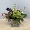 A vivid green hydrangea takes center stage in this Meadow Reverie flower