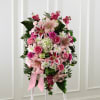 Our Standing Spray combines blushing blooms in a classic standing design to