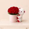 A romantic arrangement of fresh red roses designed in a chic blush