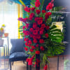 Honor a cherished life with this elegant standing spray featuring premium red