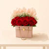 An exquisite arrangement of lush red roses and delicate baby&rsquo;s breath, beautifully