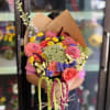 Bright pink roses and lush dahlias create an exuberant, celebratory bouquet-perfect as