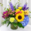 Soft, garden-fresh for the season make this arrangement feel like a warm