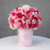 A lush dome of pinks and soft pastels makes this flower arrangement