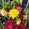 Mixed bouquet with roses and bright yellow flowers