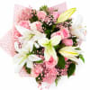 A graceful hand-tied bouquet featuring elegant white lilies, soft pink roses, delicate