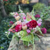 Mixed bouquet in a glass vase with pink and green blooms