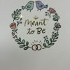 A whimsical, romantic printed greeting card that says "Meant to Be" at