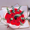 Bouquet of red roses with eucalyptus in white wrapping