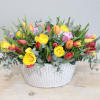 This arrangement comes in a white ceramic vase, and mixed tulips. The
