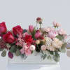 Pink and white floral arrangement in a white wooden box