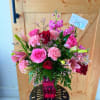 A graceful floral arrangement featuring premium roses, fragrant lilies, carnations, and seasonal