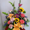 Beautiful mix flower basket with sunflowers, gladiolas, orange roses, pink carnations and