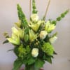 A natural colored arrangement containing Lilies, Hydrangeas, Roses, Bell Of Ireland, etc..