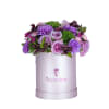 Purple floral arrangement in a lavender hat box
