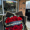 Bouquet of red roses with baby's breath and a ribbon banner