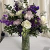 A romantic blend of soft white roses, lavender-pink chrysanthemums, and vivid purple