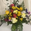 Sunlit yellow and pink roses take center stage in this joyful flower