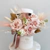 Velvety blush roses take center stage in this arrangement, softened by airy