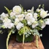 Soft white dahlias and garden roses take center stage in this elegant