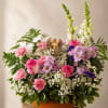 Soft pastels and a gentle silhouette make this low centerpiece a comforting