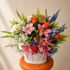 Large pink lilies take center stage in this Spring Radiance flower arrangement