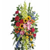 A tall standing spray that balances warmth and reverence, this sympathy spray