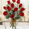 Bouquet of red roses in a clear vase with baby's breath
