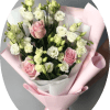 Soft pink roses paired with clusters of white lisianthus create a gently