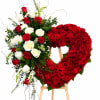 A lush heart of deeply red roses creates the first impression-bold, romantic