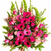 Hot pink gerbera daisies and soft pink roses take center stage in