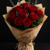 Bouquet of red roses wrapped in brown paper with twine