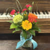 Makes someone Smile with this cute arrangement full of Beautiful Summer Colors.