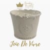 White decorative candle jar with gold logo and text