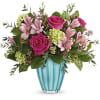 Pink roses and lilies in a blue glass vase