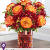 All-around arrangement with autumn-colored roses and red daisy poms; accented with solidago