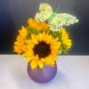 5 stunting sunflowers arranged in a purple bubble vase with a silk