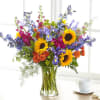 Bright sunflowers and purple irises create an immediate lift in this mixed-color