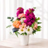 Mixed bouquet in a white vase with pink, peach, and white flowers
