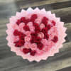 Bouquet of red and pink roses wrapped in pale pink paper