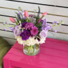 Mixed bouquet in a clear glass vase with pink, purple, and white flowers