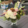 This airy and romantic centerpiece brings natural beauty and graceful color to