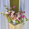 A beautiful garden-style arrangement packed with summer blooms in a blush/pastel color